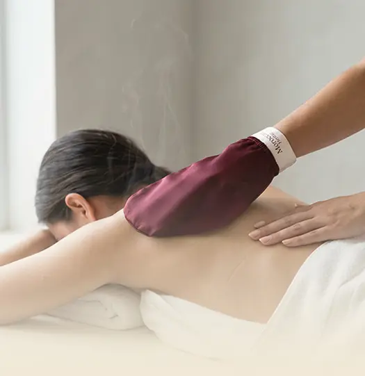A woman's hand pressing a kessa into steam